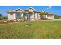 Well-maintained home showcasing a lush lawn, attractive landscaping, and a paved driveway at 14091 Peekskill Ave, Port Charlotte, FL 33981