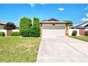 Charming single-story home featuring a two-car garage, stone accents, and a well-manicured lawn at 570 Foxwood Blvd # 196, Englewood, FL 34223