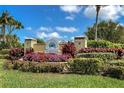 Community entrance with landscaped signage and lush greenery at 10309 Coral Landings Ct # 101, Placida, FL 33946