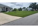 Street view of a residential neighborhood with houses and landscaping at 48 Long Meadow Ln, Rotonda West, FL 33947