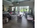 Spacious living room with large windows and view of pool at 48 Long Meadow Ln, Rotonda West, FL 33947