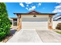 Front view of an attached garage with stone accents at 570 Foxwood Blvd # 196, Englewood, FL 34223