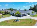 An aerial view showcasing a single-Gathering house with a spacious front yard and a paved driveway at 254 Orlando Blvd, Port Charlotte, FL 33954