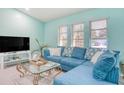 Living room with sectional sofa and large TV at 285 Mark Twain Ln, Rotonda West, FL 33947