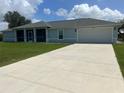 Newly built home with light blue siding and a two car garage at 13034 Marathon Blvd, Port Charlotte, FL 33981