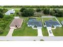 Aerial view of three houses with a shared street at 12112 Helios Ave, Port Charlotte, FL 33981