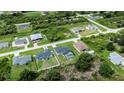An aerial view of a house with a pool and a large yard at 12112 Helios Ave, Port Charlotte, FL 33981