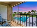 Relaxing patio overlooking a community pool with sunset views at 235 Rotonda Blvd W # C203, Rotonda West, FL 33947