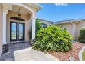 Elegant front entry with double doors, columns and mature landscaping at 639 Boundary Blvd, Rotonda West, FL 33947