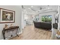 Open living space with hardwood floors, kitchen and backyard view at 9239 Harvester St, Port Charlotte, FL 33981