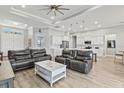 Open living room featuring a spacious layout with comfortable seating and large windows at 9239 Harvester St, Port Charlotte, FL 33981