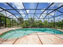 Inviting kidney-shaped pool with a screened enclosure and a large patio at 182 Rotonda N Blvd, Rotonda West, FL 33947