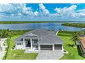 Stunning waterfront home with a private dock, lush lawn and beautiful views of the bay at 16147 Lankford Ct, Port Charlotte, FL 33981