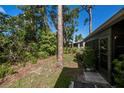 Private backyard with mature trees and landscaping at 139 Jose Gaspar Dr # 139, Englewood, FL 34223