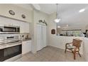 Bright kitchen with stainless steel appliances and white cabinets at 6551 Hamlet Dr # 22A, Englewood, FL 34224
