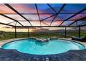 Stunning saltwater pool and spa with covered lanai offering water views at 16147 Lankford Ct, Port Charlotte, FL 33981