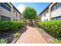 Well-maintained courtyard with brick pathway and lush landscaping at 23465 Harborview Rd # 1021, Punta Gorda, FL 33980