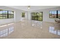 Bright living room with tile floors and sliding glass doors at 23465 Harborview Rd # 1021, Punta Gorda, FL 33980