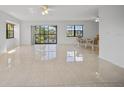 Spacious living room with tile floors and access to balcony at 23465 Harborview Rd # 1021, Punta Gorda, FL 33980