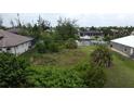 Spacious vacant lot with canal views and neighboring houses at 8356 Tecumseh Cir, Port Charlotte, FL 33981