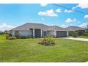 Single-story home with gray roof, white exterior, and screened-in porch at 173 Fairway Rd, Rotonda West, FL 33947