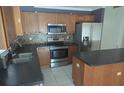 Kitchen with wood cabinets and stainless steel appliances at 2332 Potomac Mark Pl, Ruskin, FL 33570