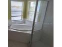 Bathroom with corner bathtub and shower at 2332 Potomac Mark Pl, Ruskin, FL 33570