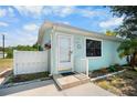 Front view of a charming light blue house at 8382 Osprey Rd, Englewood, FL 34224