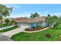 Aerial view of charming Florida home with lush landscaping at 3255 Village Ln, Port Charlotte, FL 33953