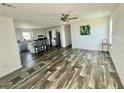Bright, open-concept living room with modern flooring and neutral color palette at 1377 Ibis Dr, Englewood, FL 34224