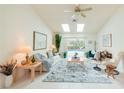 Bright living room with tile flooring, ceiling fan, and sliding glass doors to the pool at 3440 Downing W St, Englewood, FL 34224
