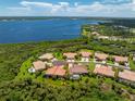 An aerial view of a waterfront property with a large backyard at 13024 Creekside Ln, Port Charlotte, FL 33953