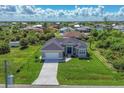 Single-Gathering home situated on a spacious lot with a canal view at 8111 Arlewood Cir, Port Charlotte, FL 33981