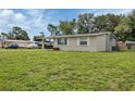 Side view of a light green single story home with a spacious yard at 2051 Mississippi Ave, Englewood, FL 34224