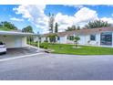 Exterior view of building with carport and walkway at 6796 Gasparilla Pines Blvd # 48, Englewood, FL 34224