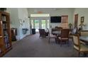Community room with seating, tables, TV, and access to a pool at 13524 Abercrombie Dr, Englewood, FL 34223