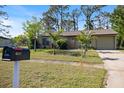Lovely single-story home featuring lush landscaping and a classic mailbox at 6517 Kenwood Dr, North Port, FL 34287