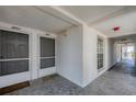Condo hallway with two apartment doors and a window at 7070 Placida Rd # 1221, Placida, FL 33946