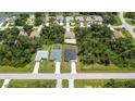 Aerial perspective showcasing a neighborhood with multiple houses and lush greenery at 205 Cougar Way, Rotonda West, FL 33947