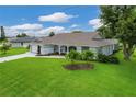 One-story home with attached garage and lush landscaping at 38 Bunker Way, Rotonda West, FL 33947