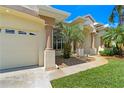 Close-up of house exterior, highlighting the garage and walkway at 14089 Newson Ln, Port Charlotte, FL 33981
