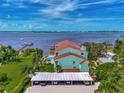 Aerial view of waterfront property with pool and parking at 53 W Bay Heights Rd # 205, Englewood, FL 34223