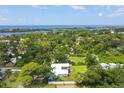 Aerial view of property showing home, lush landscaping, and waterfront access at 1730 Padre Ln, Englewood, FL 34223