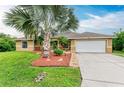 Single-Gathering home with a well-manicured lawn and palm trees at 14143 Saul Ln, Port Charlotte, FL 33981