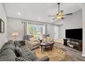 Living room with vaulted ceiling, hardwood floors, and comfy seating at 10168 Willowood Ave, Englewood, FL 34224