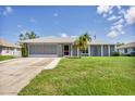 Ranch-style home with gray exterior, screened porch, and large yard at 10168 Willowood Ave, Englewood, FL 34224