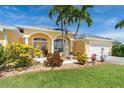 House exterior featuring a welcoming entrance and landscaping at 9 Medalist Pl, Rotonda West, FL 33947