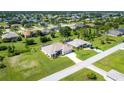 Aerial view of a single-Gathering home with a large backyard and surrounding community at 283 Long Meadow Ln, Rotonda West, FL 33947