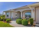 Single story home with manicured landscaping and fountain at 283 Long Meadow Ln, Rotonda West, FL 33947