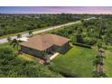Aerial view of a single-story house with a large backyard at 191 Brig W Cir, Placida, FL 33946